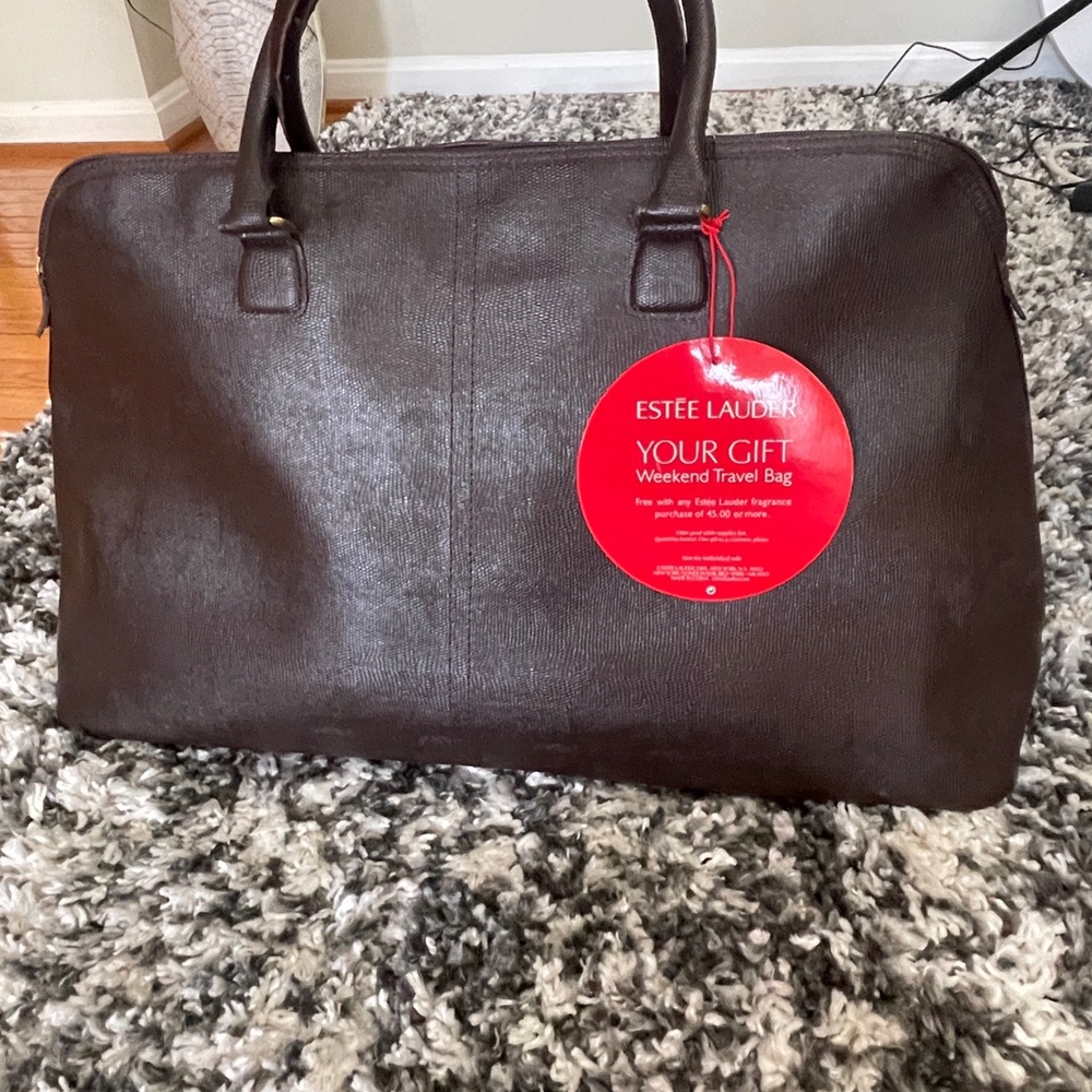 Dark Brown Leather Duffle Bag with Red Tag and Structured Design